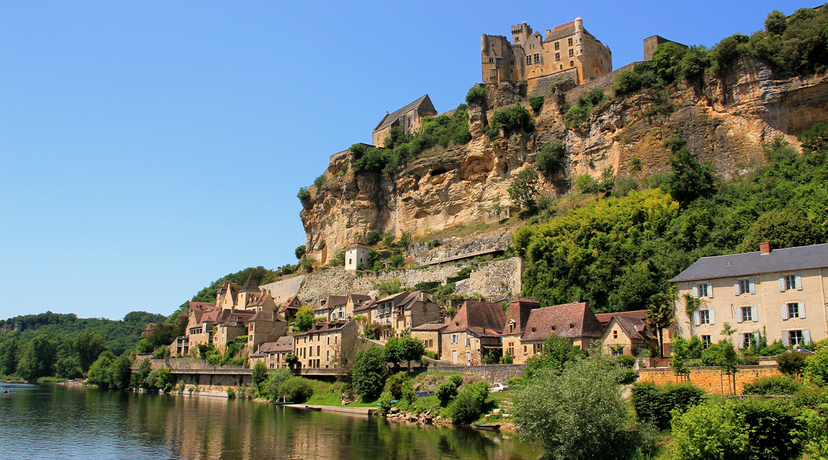 French town set into a hillside on riverbank